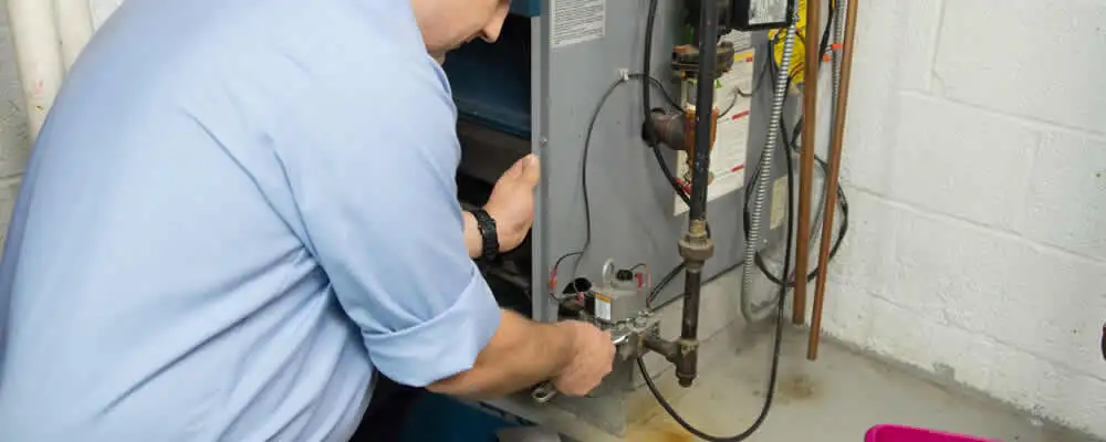Furnace repair technician inspecting and servicing a home heating system in Brandon, FL