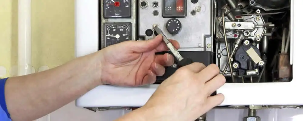 Heating repair technician adjusting boiler controls and components in Brandon, FL
