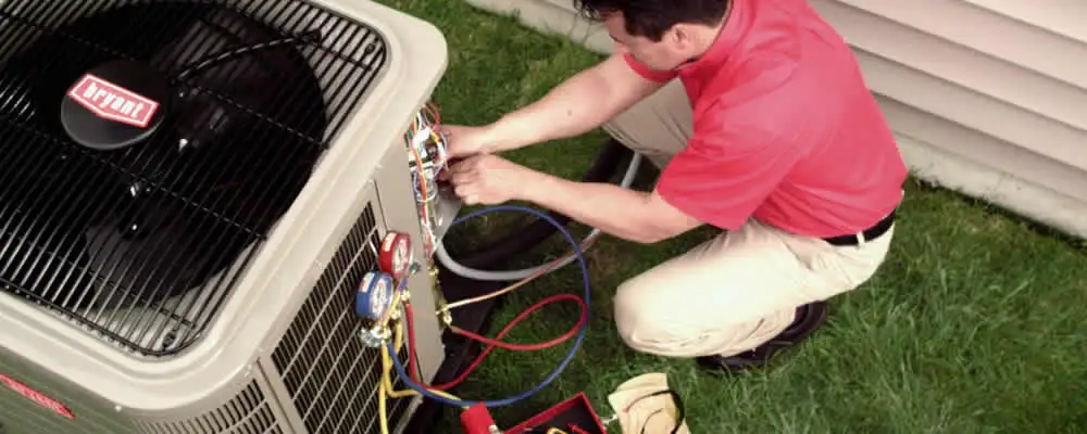 HVAC technician servicing an outdoor air conditioner unit in Brandon, FL