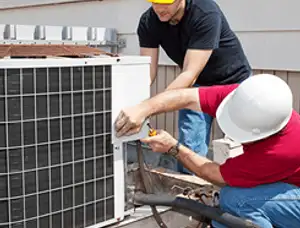 HVAC technicians repairing an outdoor AC unit on a rooftop in Brandon, FL