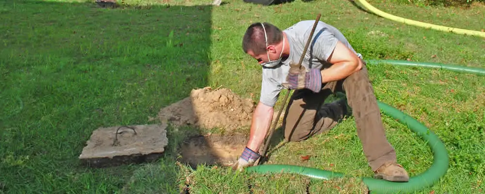 Septic pumping technician servicing a residential septic tank in Brandon, FL